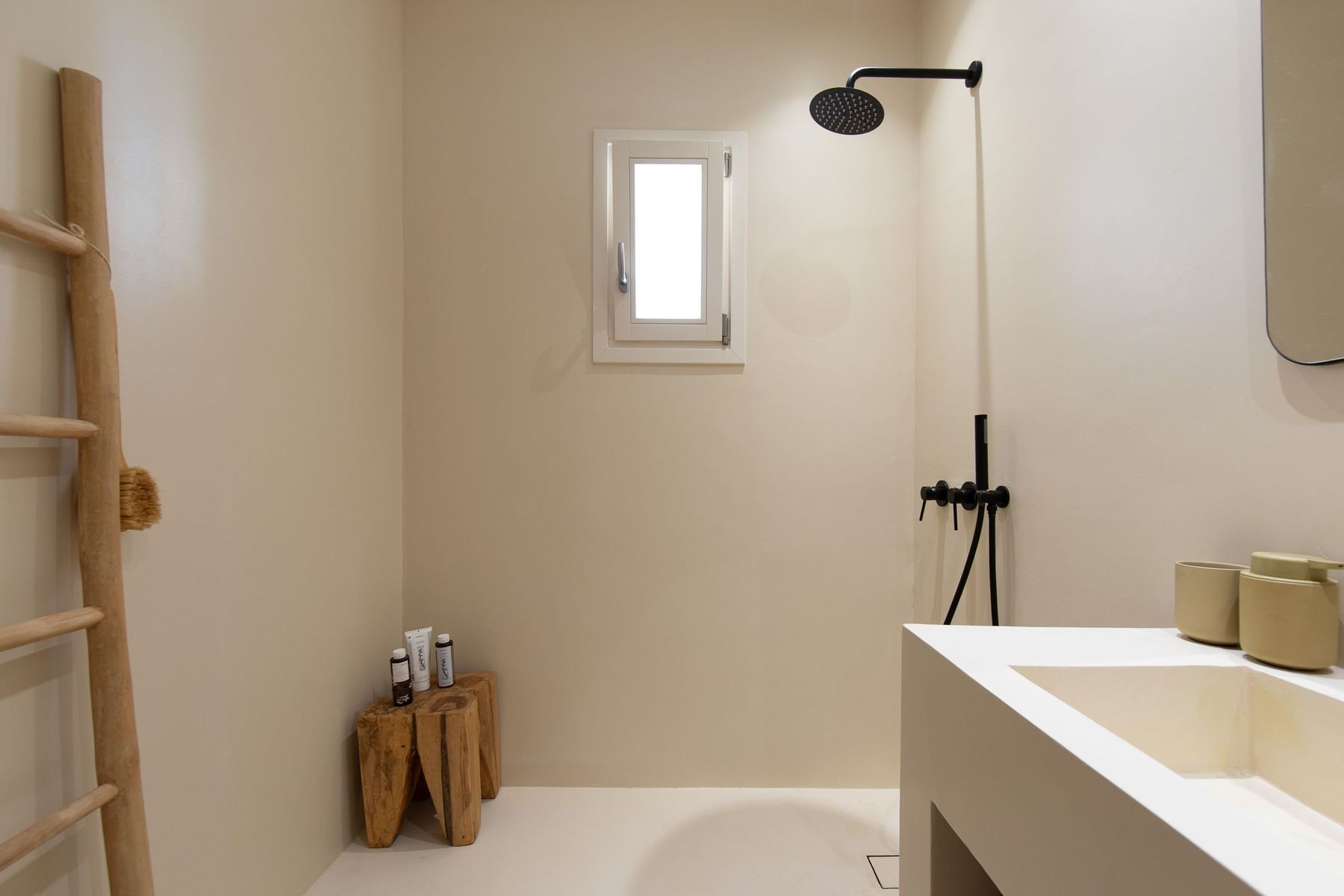 Shower room lit by a small square window