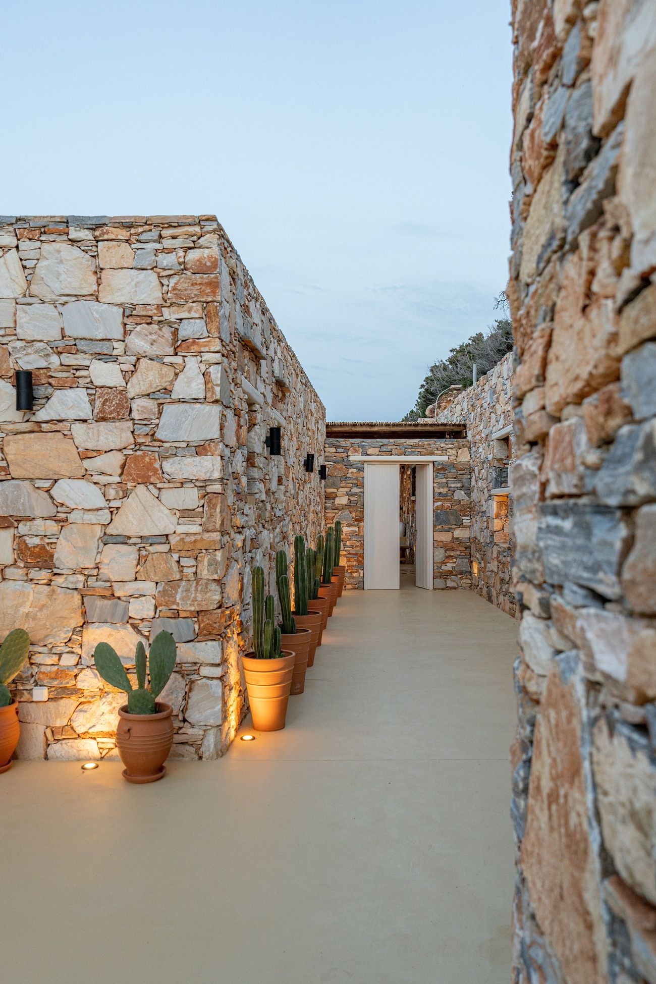 The stone passage between the two buildings at dusk