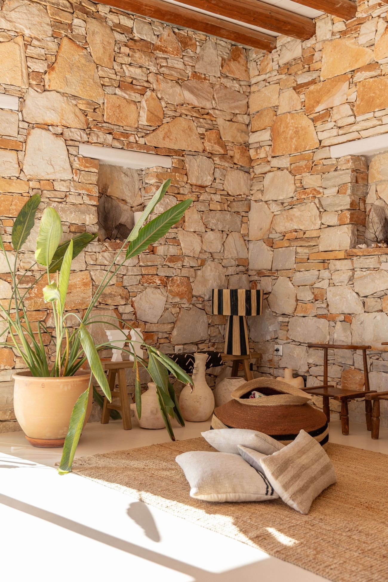 A corner of the living room against the stone wall