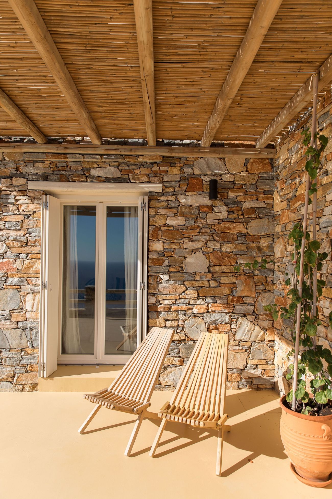 Wooden chairs in the shade of the pergola