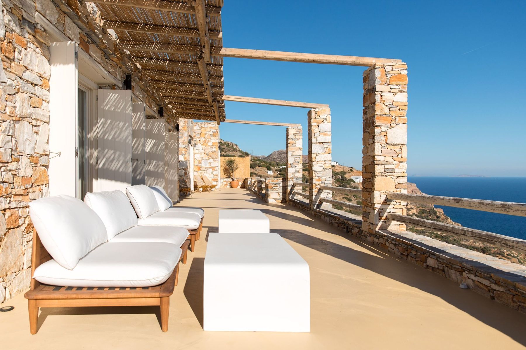Daybeds along the terrace, the sea below